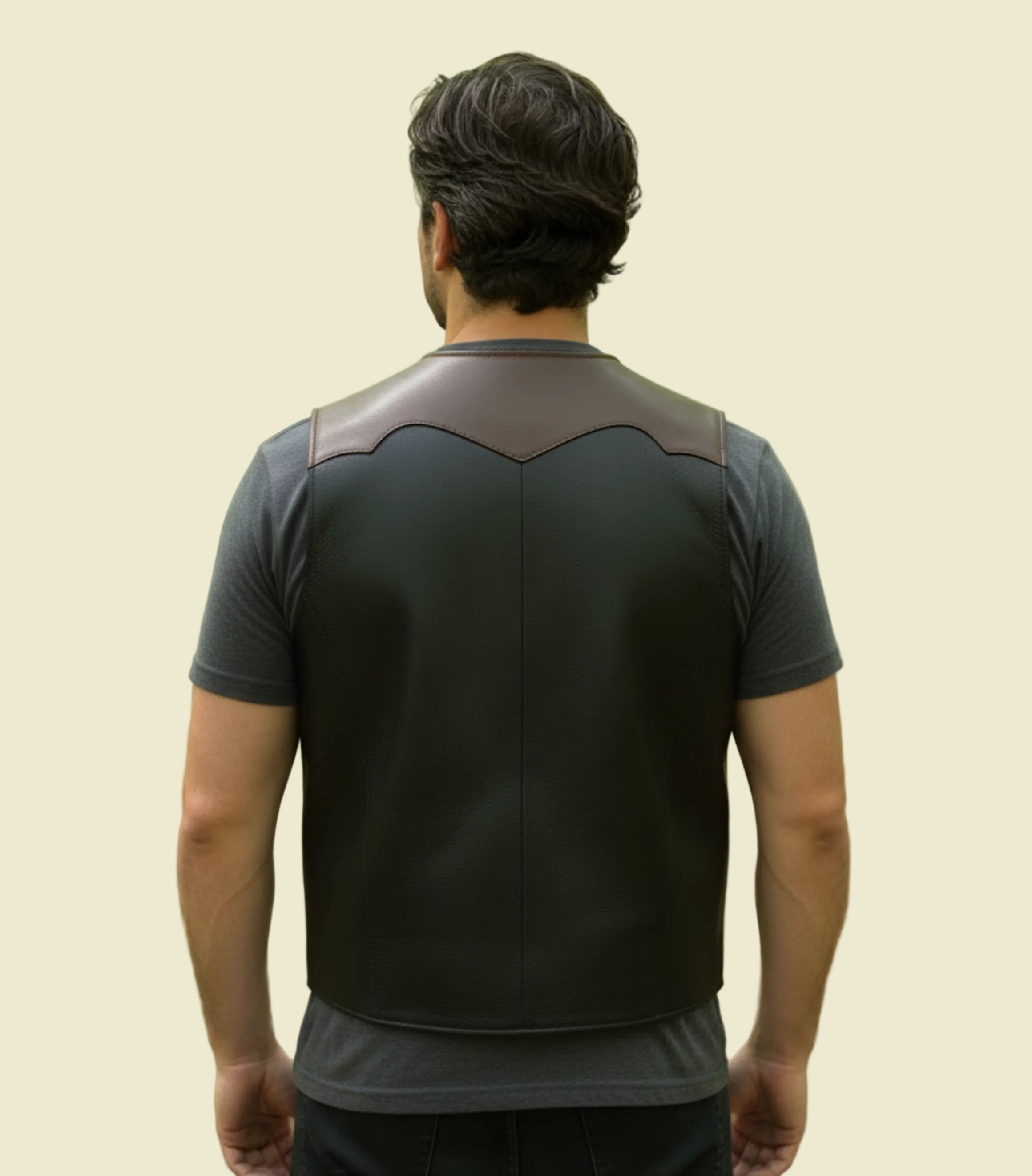 Black leather vest with brown accents on a grass background