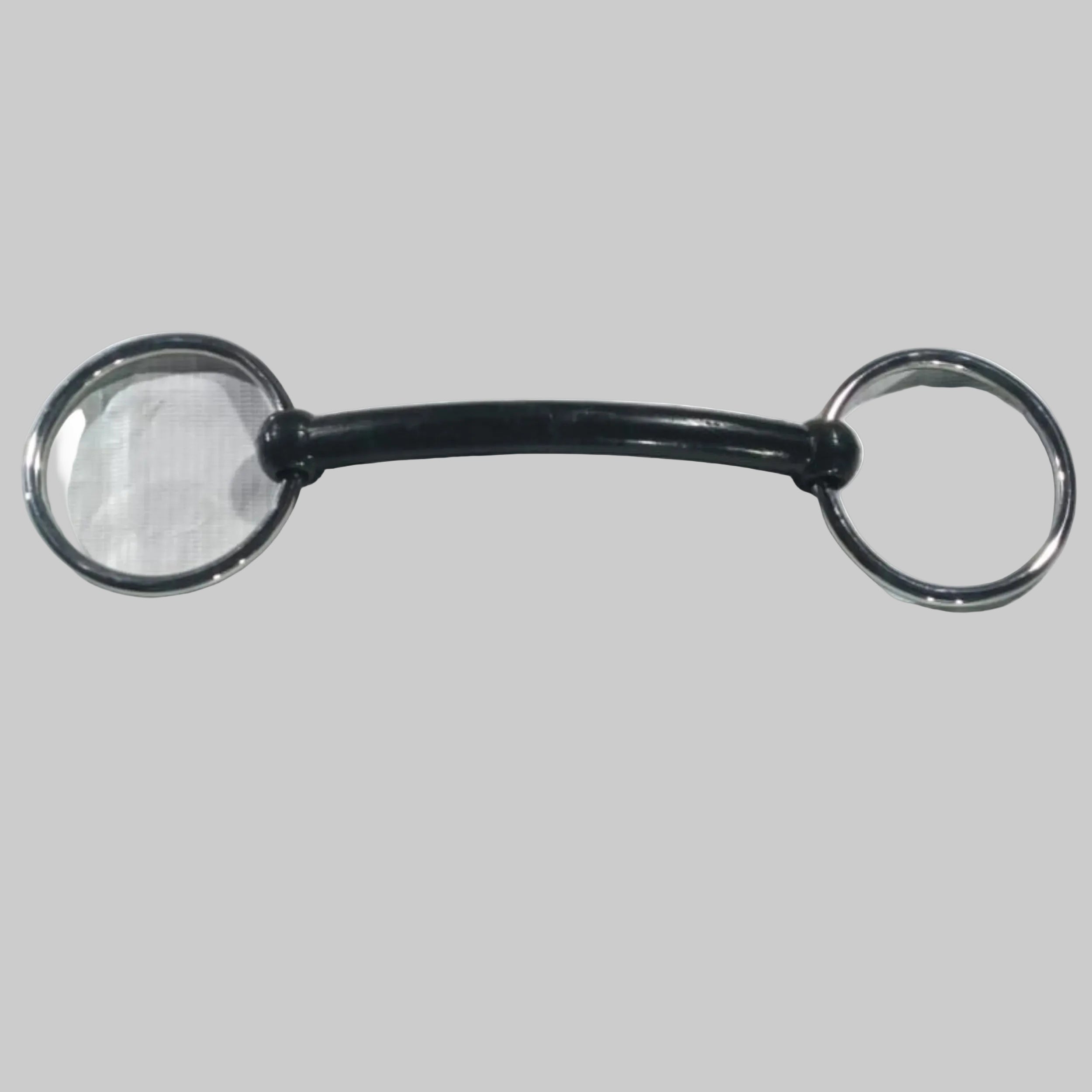 Black metal bridle bit with silver rings on a white fabric background